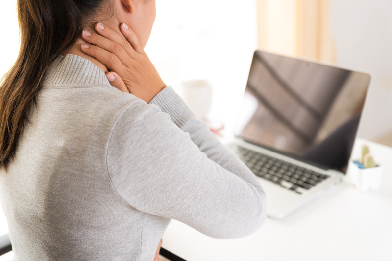 Closeup woman with hands holding her shoulder pain. Office syndr